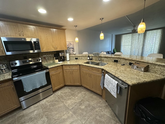 kitchen with decorative light fixtures, sink, decorative backsplash, kitchen peninsula, and stainless steel appliances