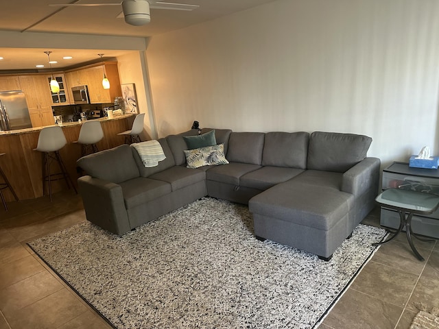 tiled living room with ceiling fan