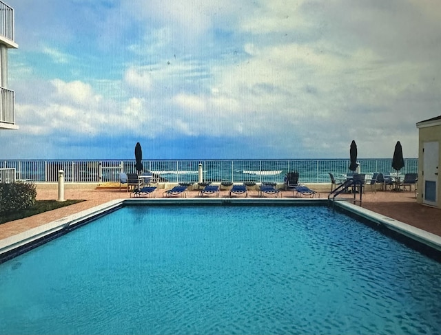 view of swimming pool featuring a patio area