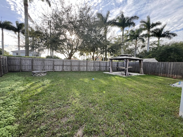 view of yard featuring a fenced backyard, a patio, and a gazebo