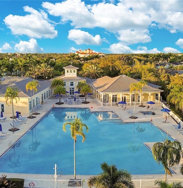 community pool featuring a patio and fence