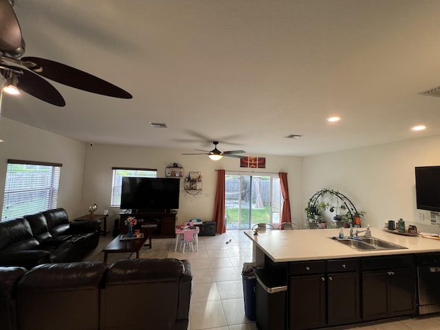 living room with ceiling fan, light tile patterned flooring, and sink