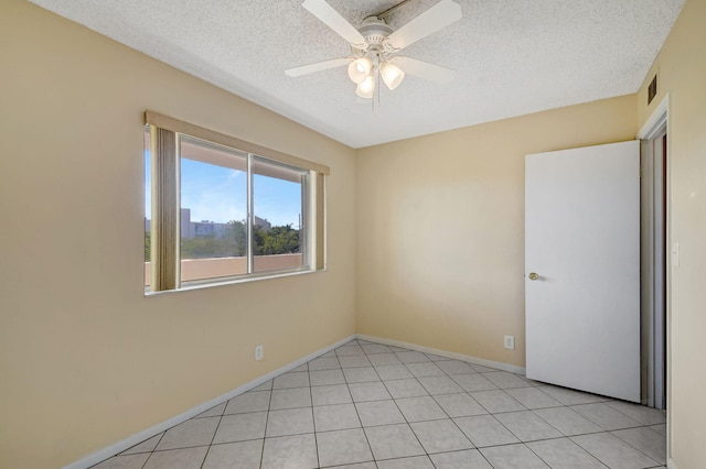 unfurnished room featuring light tile patterned flooring, a textured ceiling, and ceiling fan