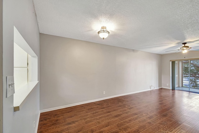 spare room featuring a textured ceiling, dark wood-type flooring, and ceiling fan