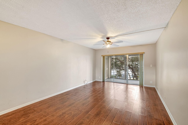 spare room featuring a textured ceiling, wood-type flooring, and ceiling fan