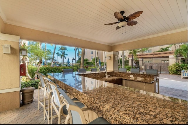 view of patio / terrace with a bar and ceiling fan