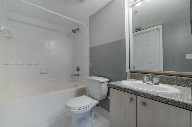 full bathroom featuring tile patterned floors, vanity, toilet, and tiled shower / bath combo