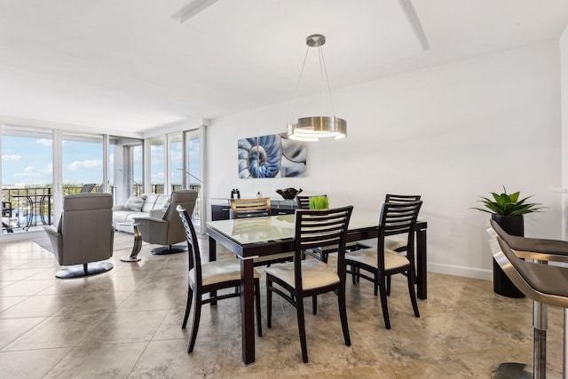 dining room featuring light tile patterned floors and floor to ceiling windows