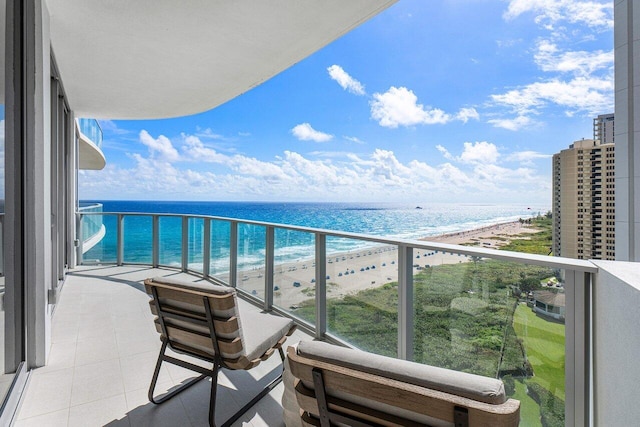 balcony with a water view and a beach view