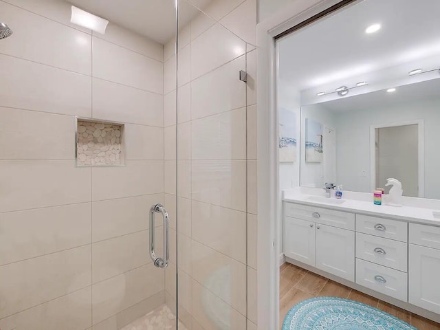 bathroom featuring vanity and an enclosed shower