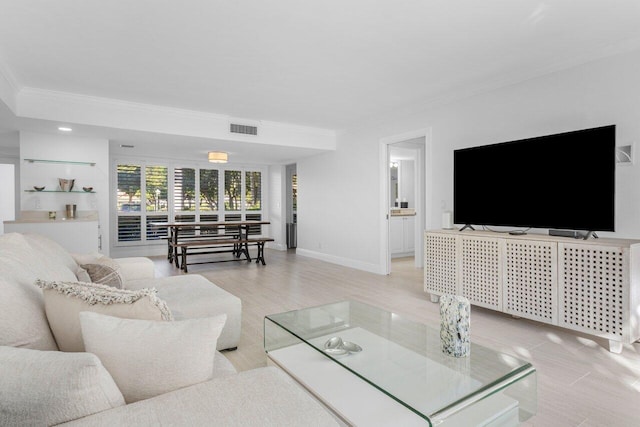 living room featuring crown molding and light wood-type flooring