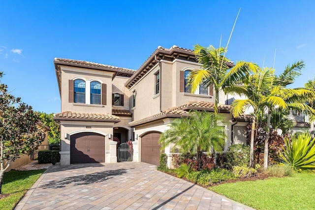 mediterranean / spanish-style home with a garage