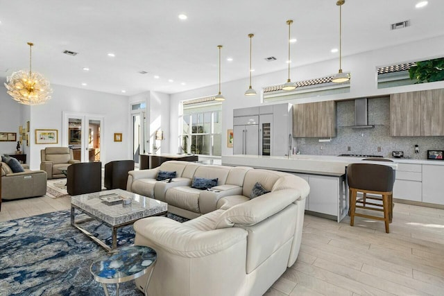 living room with french doors and light hardwood / wood-style flooring