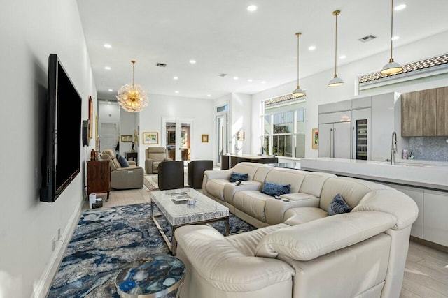 living room featuring sink and light hardwood / wood-style flooring