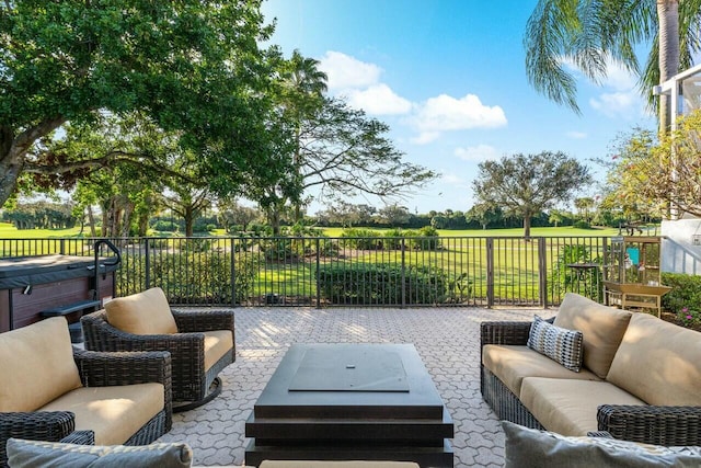 view of patio with an outdoor living space and a hot tub