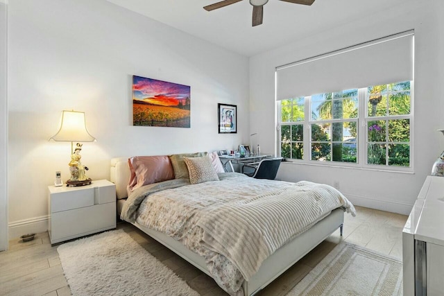 bedroom with ceiling fan and light wood-type flooring