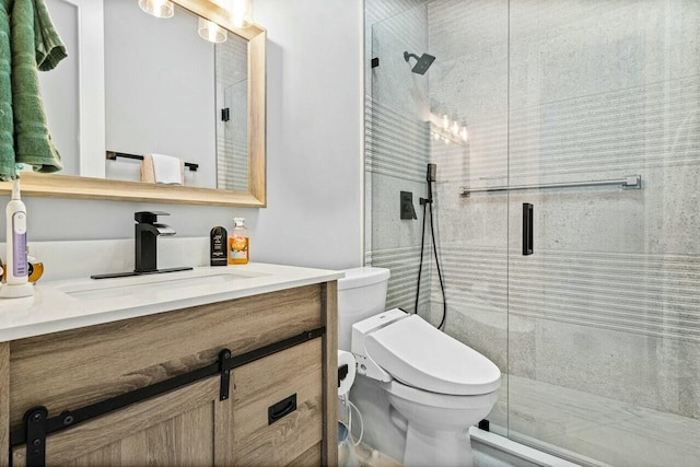 bathroom featuring a shower with door, vanity, and toilet