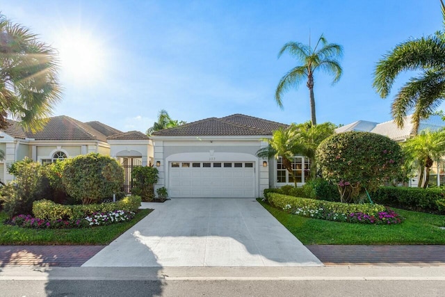 mediterranean / spanish-style house with a garage