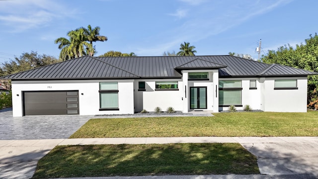 view of front of property featuring a garage and a front lawn