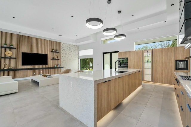 751 Pelican Way, North Palm Beach, FL 33408 - kitchen featuring modern cabinets, a sink, stainless steel gas cooktop, and a large island