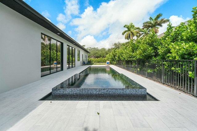 751 Pelican Way, North Palm Beach, FL 33408 - view of pool featuring fence and a patio area