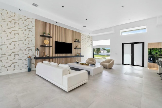 751 Pelican Way, North Palm Beach, FL 33408 - living area featuring an accent wall, a high ceiling, and wallpapered walls