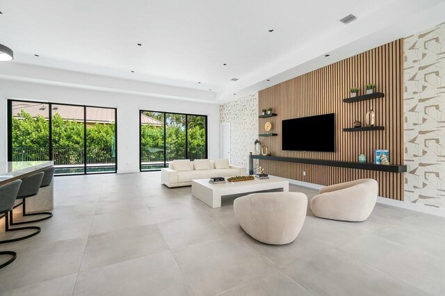 751 Pelican Way, North Palm Beach, FL 33408 - living area featuring wallpapered walls and an accent wall