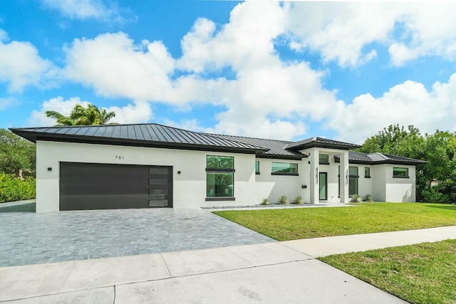 751 Pelican Way, North Palm Beach, FL 33408 - view of front of home featuring a standing seam roof, metal roof, stucco siding, and decorative driveway