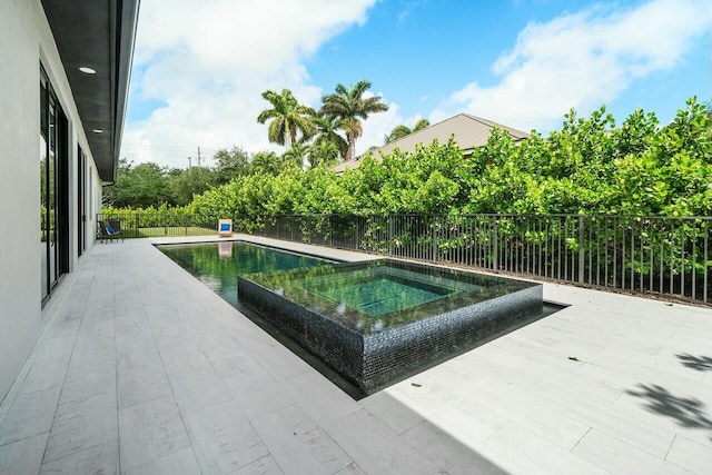 751 Pelican Way, North Palm Beach, FL 33408 - view of pool featuring an in-ground hot tub, a patio area, and fence