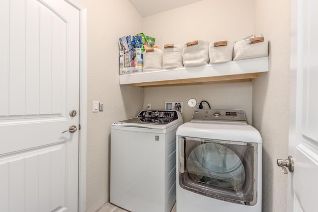 laundry area featuring washing machine and clothes dryer