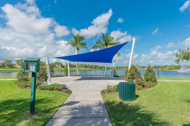 view of community with a water view and a yard