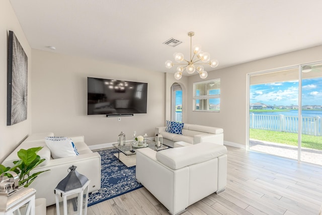 living room featuring a notable chandelier and light hardwood / wood-style flooring