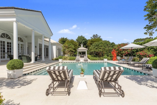 view of swimming pool with a gazebo, a fenced in pool, french doors, and a patio