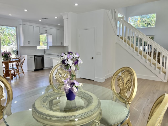 dining room with sink and light hardwood / wood-style floors