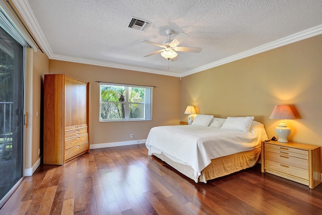 bedroom featuring ceiling fan, crown molding, dark wood-type flooring, and a textured ceiling