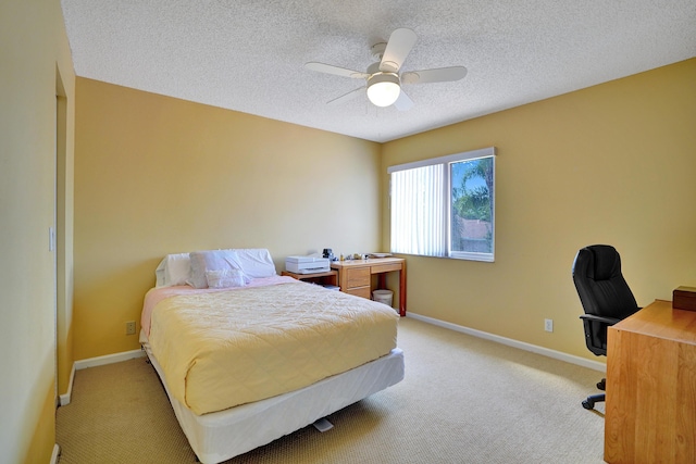 bedroom with light carpet, ceiling fan, and a textured ceiling