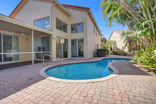 view of pool with ceiling fan and a patio