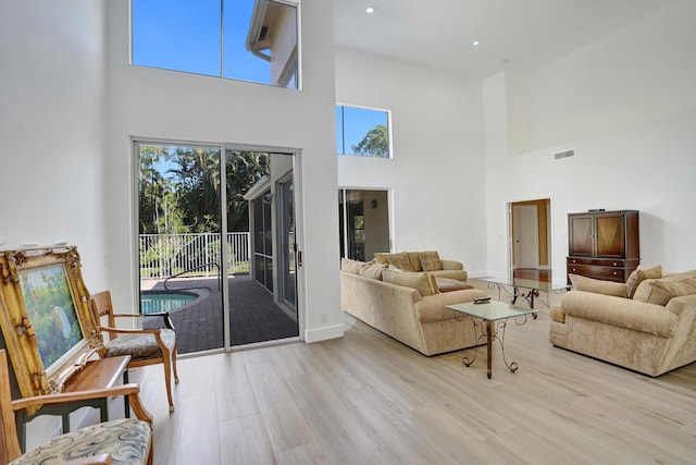 living room featuring a healthy amount of sunlight and light hardwood / wood-style floors