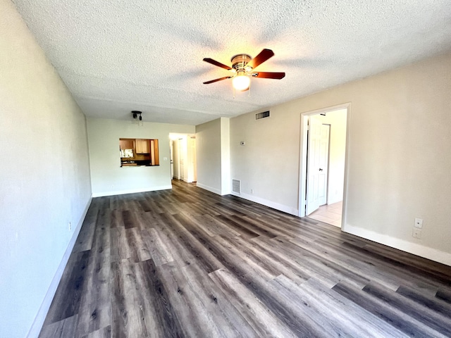 unfurnished living room with a textured ceiling, dark hardwood / wood-style floors, and ceiling fan