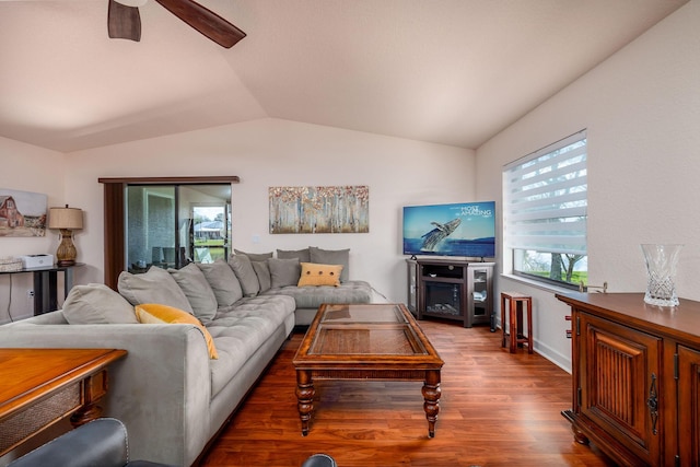 living room with hardwood / wood-style flooring, vaulted ceiling, and ceiling fan