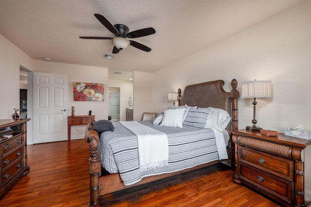 bedroom with dark hardwood / wood-style floors, connected bathroom, and ceiling fan