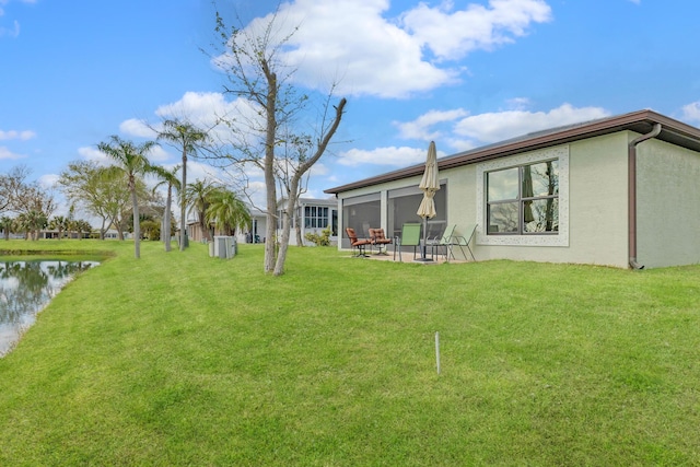 view of yard with a patio area and a water view