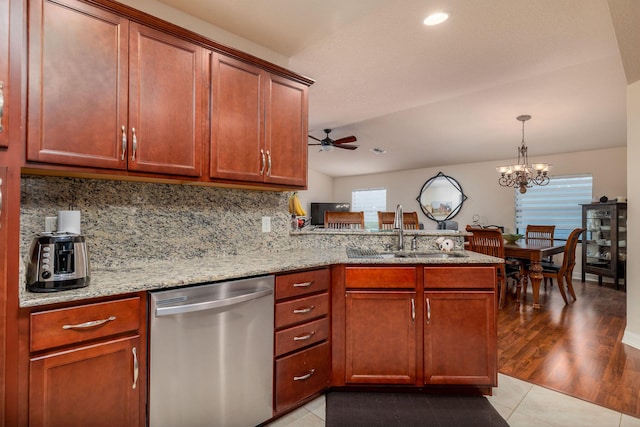 kitchen featuring sink, dishwasher, backsplash, light stone countertops, and kitchen peninsula