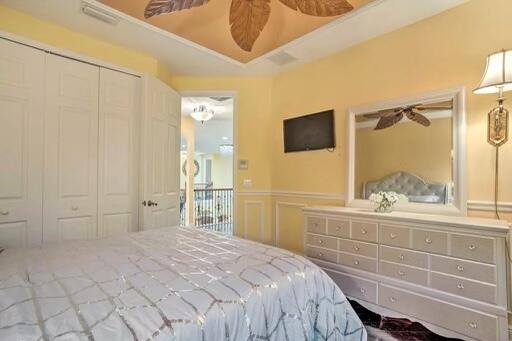 bedroom with a tray ceiling and a closet