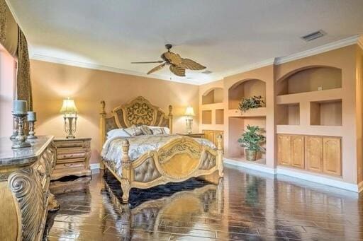 bedroom featuring wood-type flooring and crown molding