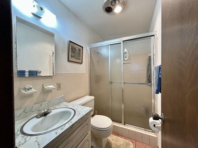 600 NW 344th St, Okeechobee, FL 34972 - bathroom featuring tile patterned flooring, tile walls, an enclosed shower, vanity, and toilet