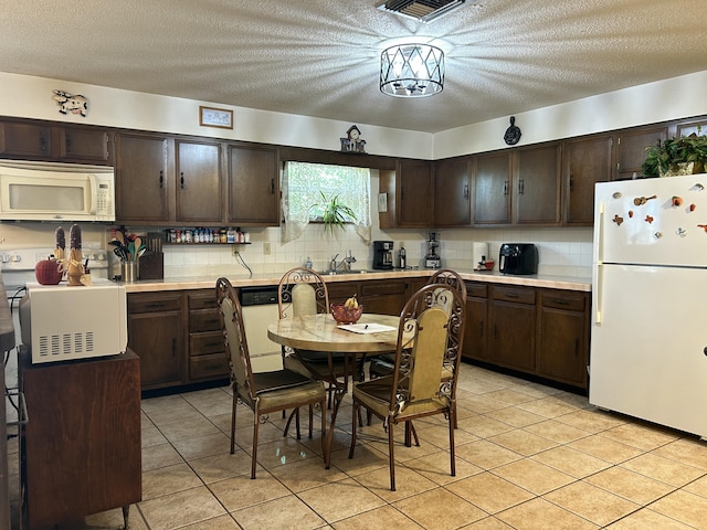 600 NW 344th St, Okeechobee, FL 34972 - kitchen featuring sink, white appliances, dark brown cabinets, and decorative backsplash