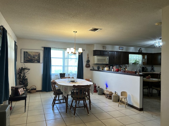 600 NW 344th St, Okeechobee, FL 34972 - tiled dining space featuring a chandelier and a textured ceiling