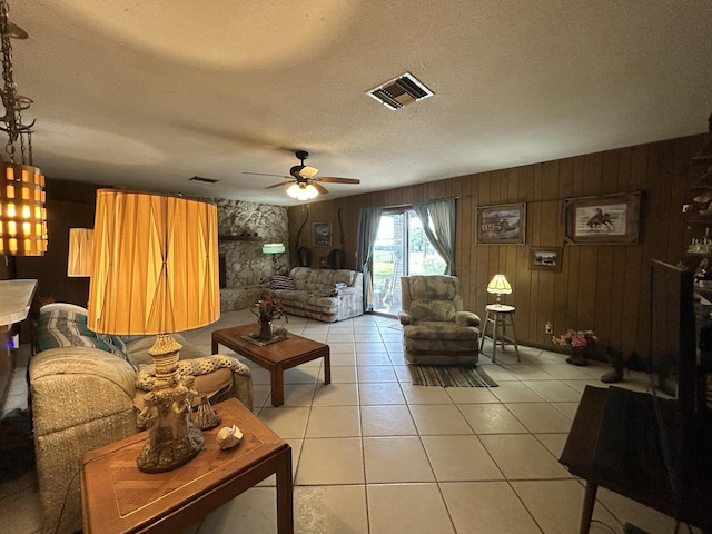 600 NW 344th St, Okeechobee, FL 34972 - living room with ceiling fan, wood walls, a textured ceiling, and light tile patterned flooring