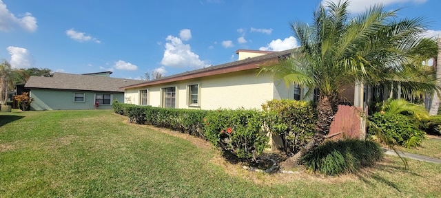 view of side of home with a lawn